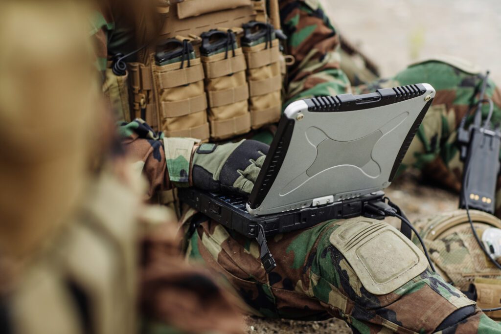 Soldier works on his laptop